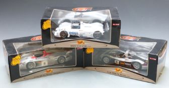 Three Maisto GT Racing 1:18 scale diecast model cars comprising BMW V12 LMR and Audi R8R Le Mans and