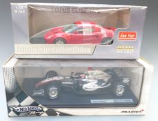 Two 1:18 scale diecast model vehicles Sun Star Lotus Elise 111S 1032 and Hot Wheels Racing McLaren