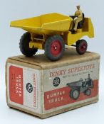 Dinky Supertoys diecast model Dumper Truck with yellow body, red hubs and beige driver, 562, in