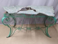 Victorian cast iron conservatory/ garden table of serpentine shape raised on ornate scrolling legs.