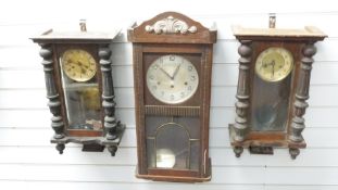 Three circa Edwardian wall clocks, one a three train example, the others two train striking on a