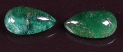 A pair of loose pear cut emeralds, each approximately 4.25ct