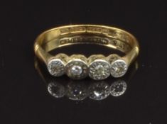 An 18ct gold ring set with five diamonds in a platinum setting, size L, 2g
