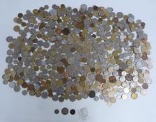 A tin containing a collection of overseas coinage, largely pre-Euro holiday change, but also