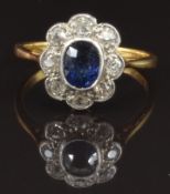 An 18ct gold ring set with an oval cushion cut sapphire of approximately 0.5ct surrounded by