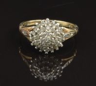 A 9ct gold ring set with diamonds in a cluster, size K, 2.3g