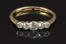An 18ct gold ring set with five diamonds in a platinum setting, size K, 1.7g