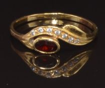 A yellow metal ring set with a garnet and cubic zirconia, marked 800, size R, 1.9g