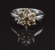 An 18ct white gold ring set with a cluster of round cut champagne diamonds, total approximately  0.