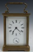 Brass carriage clock with alarm function, stamped ACG inside with Roman numerals to the enamelled