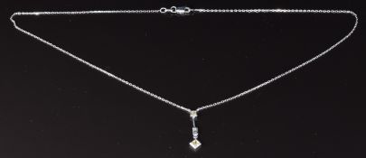 An 18ct white gold necklace set with two princess cut fancy yellow diamonds and a baguette cut