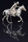 A 9ct gold pendant in the form of a polo player, 3.2 x 3cm, 8.9g