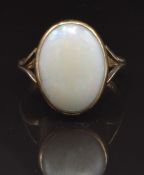 A 9ct gold ring set with a white opal cabochon, size R, 3.9g