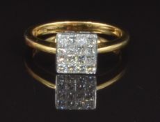 An 18ct gold ring set with approximately 0.5ct of square cut diamonds, size N, 3.6g