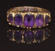 A 9ct gold ring set with five oval cut amethysts, size P, 2.9g