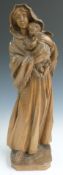German carved wooden figurine depicting a robed woman with babe in arms, indistinct maker's stamp to