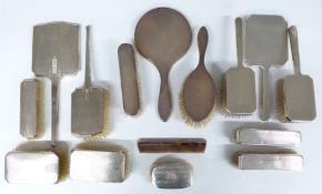 Three hallmarked silver mounted dressing table sets including a Mappin & Webb set, 14 pieces in