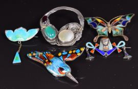 A collection of brooches including Arts and Crafts example set with agate, garnet and mother of
