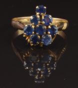 A yellow metal ring set with eight round cut sapphires, size O, 2.2g