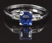 A platinum ring set with an untreated Asscher cut sapphire and a baguette cut diamond to each