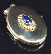 A 9ct gold locket set with a sapphire cabochon, 4.2g