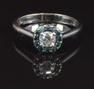 An 18ct white gold ring set with a diamond of approximately 0.25ct surrounded by blue diamonds, size