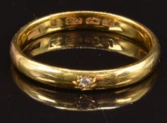 A 22ct gold wedding band/ ring set with a diamond in a star setting, Birmingham 1920, size S, 3.8g