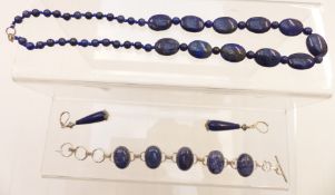 A beaded lapis lazuli necklace, a silver bracelet set with lapis lazuli and similar earrings