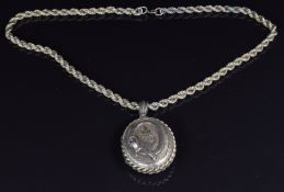 Victorian silver gilt locket with chased decoration and applied buckle decoration and a rope twist