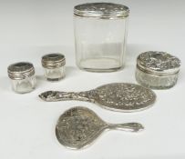 Four hallmarked silver lidded cut glass dressing table pots and two novelty miniature dressing table