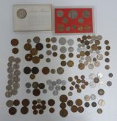 Maria Theresa silver coin and further world coinage, in a vintage tin
