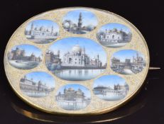 A c1900 yellow metal Indian brooch set with an ivory miniature depicting nine views of notable