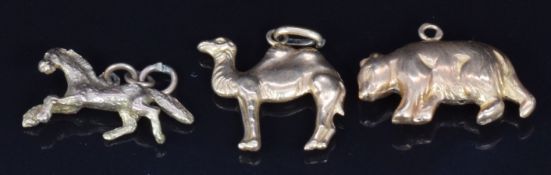 Two yellow metal charms, one in the form of a bear the other a camel, 2.3g, and a 9ct gold horse