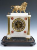 French 19thC mantel clock in onyx case supported by gilt brass reeded columns surmounted by standing