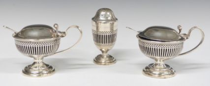 George V hallmarked silver three piece cruet set with blue glass liners and pierced bodies
