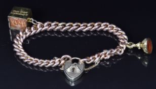 A 9ct rose gold bracelet with a 9ct gold ten shilling note charm and a Victorian fob set with agate,