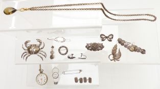 A collection of silver jewellery including pin, Scottish silver brooch, large brooch in the form