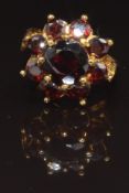 A 9ct gold ring set with a cluster of garnets, size L, 4.7g