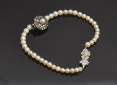 A section of natural pearls with a 9ct white gold clasp set with a diamond