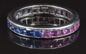 A platinum eternity ring set with square cut pink and blue sapphires, size O, 4.3g