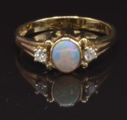 A 9ct gold ring set with an opal and two diamonds, size N, 2.6g