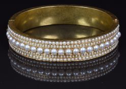 Victorian gold bangle set with a central row of split pearls flanked by two rows of seed pearls,