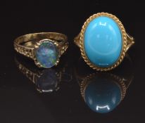 A 9ct gold ring set with a faux turquoise cabochon, size O, and a 9ct gold ring set with an opal