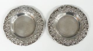 Pair of Egyptian white metal pin trays with embossed floral borders, diameter 9.5cm, weight 98g