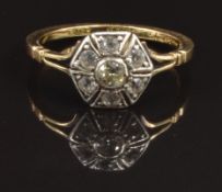 An 18ct gold ring set with a diamond surrounded by white sapphires, size M, 2.6g