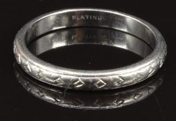 A platinum wedding band/ ring with engraved decoration, size L/M, 3.6g