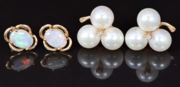 A pair of 14k gold earrings set with three pearls and a diamond and a pair of 9ct gold earrings