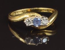 A 9ct gold ring set with a round cut sapphire and two diamonds, size M, 3.7g