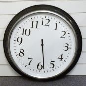 A large metal wall clock with black Arabic numerals, white dial and chrome bezel, 60cm in diameter