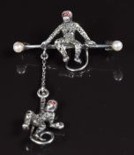 A silver brooch in the form of two monkeys, set with marcasite and pearls